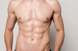 © LIGHTFIELD STUDIOS - cropped view of sexy man with muscular torso isolated on grey