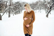 © Louis-Photo - Young happy pregnant woman in snowy forest