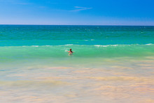 Swimming Person In Turquoise Waters At Algharve Coast In Portugal In Summer