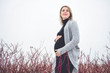 © Louis-Photo - Young happy pregnant woman in snowy forest