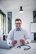 © bnenin - Positive healthcare worker holding blank paper in medical office.