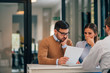 © bnenin - Financial adviser with young couple at banking meeting, portrait.