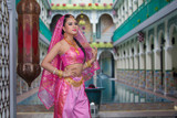 Fototapeta Londyn - Portrait beautiful Asian Muslim or Indian woman Indian style beside the pool in a Muslim house.