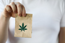 Courier Hand Passing Package With Marijuana To Client Close-up