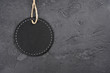 Round wooden blackboard mockup on gray concrete background. Sale, Black Friday, tag, invitation, card concept. Top view, flat lay, copy space