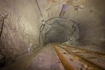 Underground gold mine shaft tunnel drift with rails