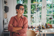 Portrait of young female confident graphic designer in casual look wearing eyeglasses working at her modern office with big light windows, Creative People Business Startup Concept