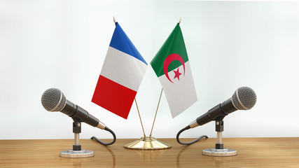 Wall Mural - Microphones and flags pair on a desk over defocused background