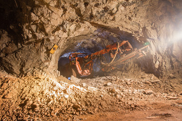 Canvas Print - Underground gold bauxite mine shaft tunnel with drilling machine