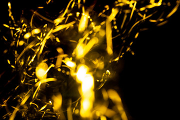 Wall Mural - abstract texture of Golden sparkles on a black background, Golden highlights in the form of spirals and iridescence