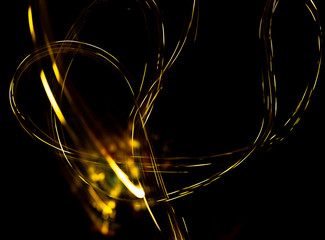 Wall Mural - abstract texture of Golden sparkles on a black background, Golden highlights in the form of spirals and iridescence