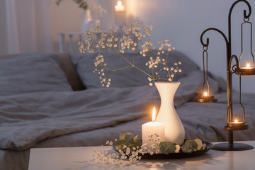 antique candlestick with burning candles in bedroom