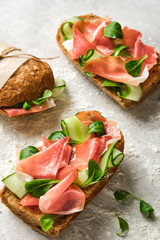 Wall Mural - Italian sandwiches with bacon, cucumber and fresh herbs. Ciabatta with meat