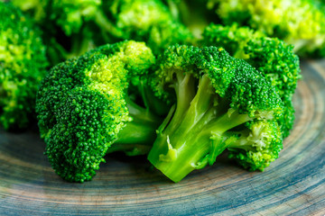 Macro photo green fresh vegetable broccoli. Fresh green broccoli on a black stone table.Broccoli vegetable is full of vitamin.Vegetables for diet and healthy eating.Organic food.