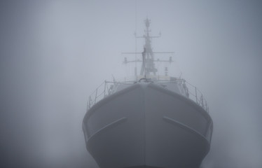 Ghost ship. Warship in the fog or mist as a flying Dutchman. Gray color. Mystery concept. Pirate Code, doomed vessel rise from the sea, spreading terror across the ocean lore. phantom ship doomed