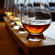 Scotch Whisky, Tasting Glasses With Variety Of Single Malts Or Blended Whiskey Spirits On Distillery Tour In Scotland