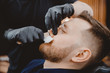 © Parilov - Hair removal with wax from man nose, beauty and care procedure depilation in barbershop