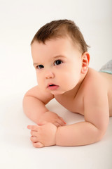 Wall Mural - portrait of a healthy baby boy, baby looking at the camera smiling, baby 9 months on a white background