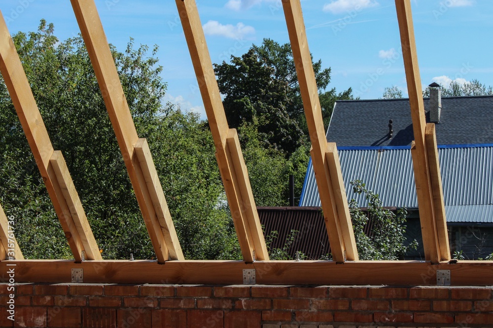 Teachment Under Rafter Roof trusses not covered with ceramic tile on a detached house under ...