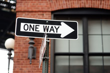'One Way' Road Signs On The Wall Of Building In New York.