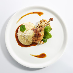 Wall Mural - Duck Leg Confit with Pearl Barley on Restaurant Plate Isolated