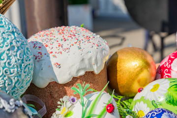 Easter street vestival in Moscow, Russia. Wicker basket full of painted easter eeggs, cake and flowers.