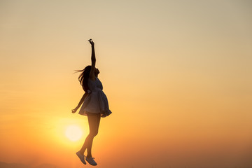 Wall Mural - Young asia woman jumping in the sky and feeling free,happy