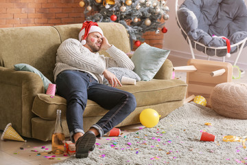 Sticker - Young man with hangover after New Year party at home