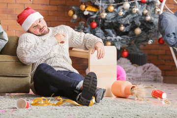 Sticker - Young man with hangover after New Year party at home