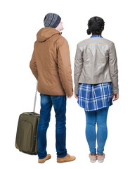 Wall Mural - young couple in winter jacket traveling with suitcas.