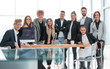 © ASDF - team of young professionals standing near the desktop