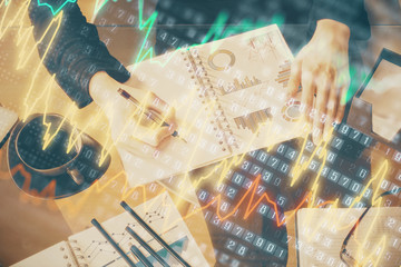 Multi exposure of hands making notes with forex chart huds. Stock market concept.