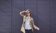 © jozzeppe777 - Smiling trendy model in sunglasses posing near wall. copy space