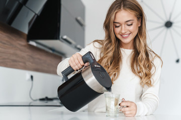 Sticker - Photo of beautiful happy woman smiling and making tea