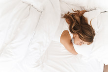 Photo Of Young Caucasian Woman Sleeping And Hugging Pillow