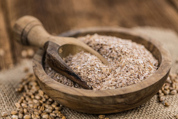 Portion of healthy Wheat Bran (selective focus; close-up shot)