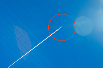 Wall Mural - aircraft conversion track. blue sky. red optical sight. aircraft in sight.