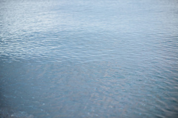 Wall Mural - Blue ripple water wave on sand in sea ocean for background