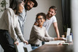 © Drobot Dean - Image of multiethnic young business people working together at office
