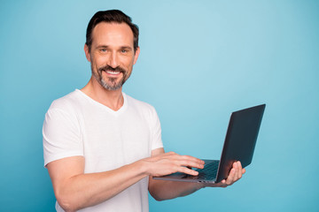 Sticker - Close-up portrait of nice attractive cheerful cheery successful guy tech support geek using laptop developing career isolated on bright vivid shine vibrant teal green blue turquoise color background