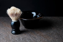 Shaving Brush And Bowl On The Stone Surface At Black Background