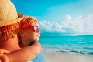 father and cute little daughter loving hug at beach