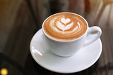 Fototapeta Kamienie - hot latte coffee put on table in cafe restaurant, drink breakfast in the morning day