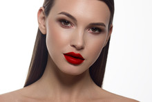 Close-up Portrait Of Sexy European Young Woman Model With Classic Glamour Make-up And Red Lipstick. Dark Long Hairstyle, Christmas Makeup, Dark Eyeshadows, Bloody Red Lips With Gloss