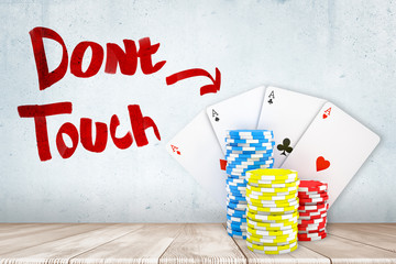 Poster - 3d rendering of casino tokens and playing cards on white wooden floor with 'don't touch' sign on whi