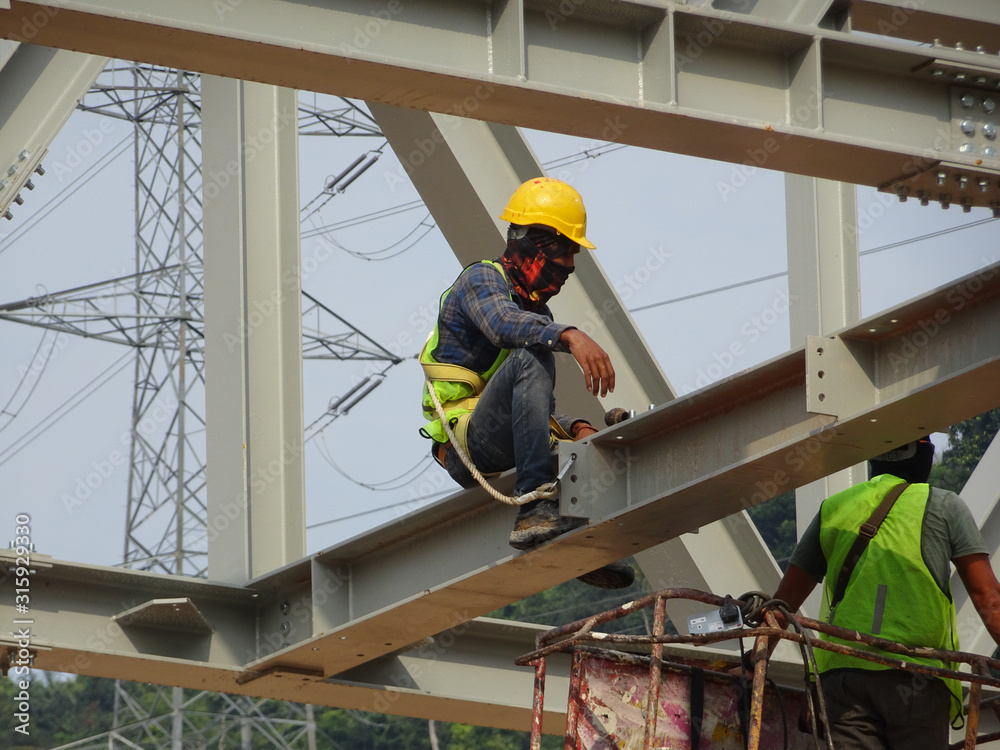 Construction workers working at height installing the steel structure ...