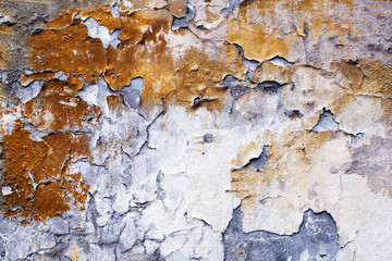 Old wall with flaking paint. Rough vintage background