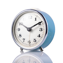 Blue retro alarm clock on a white isolated background, close-up.