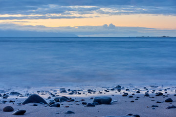 Poster - The sea after sundown and pebble beach at dawn