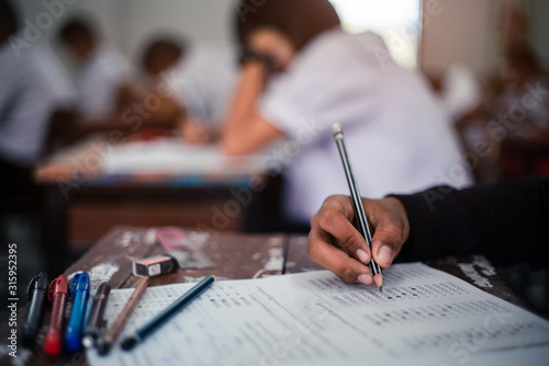 Fotomural Students taking exam with stress in school classroom.